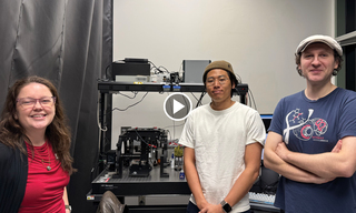 Julia Staverosky Ph.D., Bogdan Bintu Ph.D., Samuel Park Ph.D. Candidate standing in front of microscope set up 