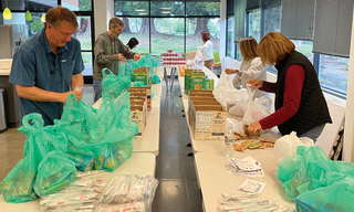 6 people packing lunches at Portland Backpack Program