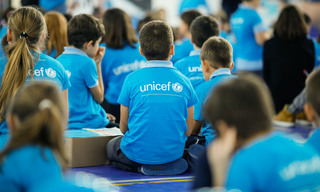 Bucharest, Romania - November 19, 2019: Children wearing Unicef shirts take part at an event. Unicef logo.